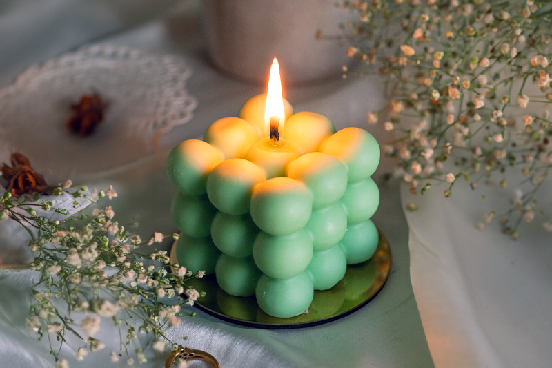 Scented candles creating a calming atmosphere, enhancing mood and mental wellness.