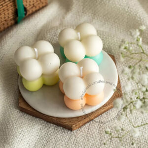 Colorful Mini Bubble Candles by Windowsill displayed on a wooden coaster, featuring soft pastel colors perfect for home decor.